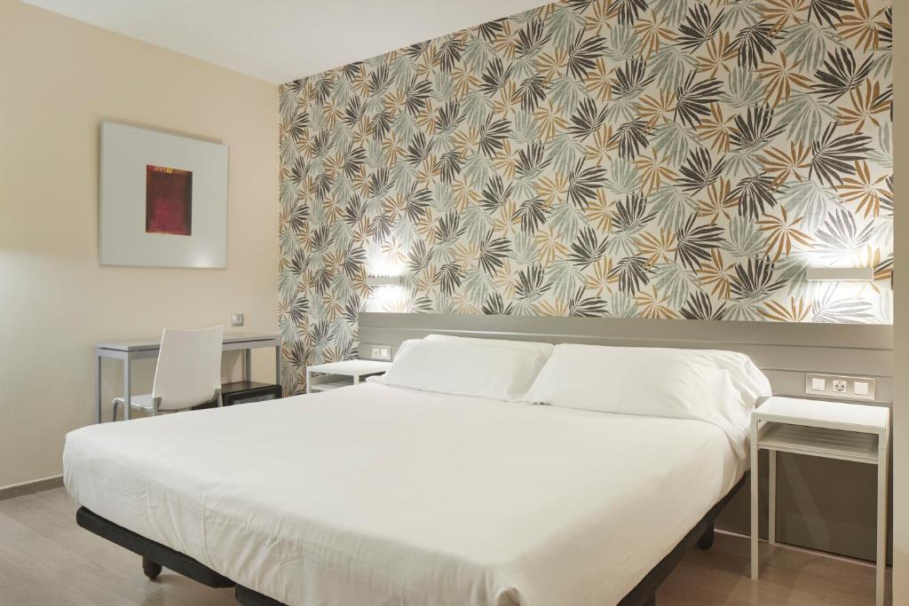 Postel nebo postele na pokoji v ubytování Welcome Gros Hotel
