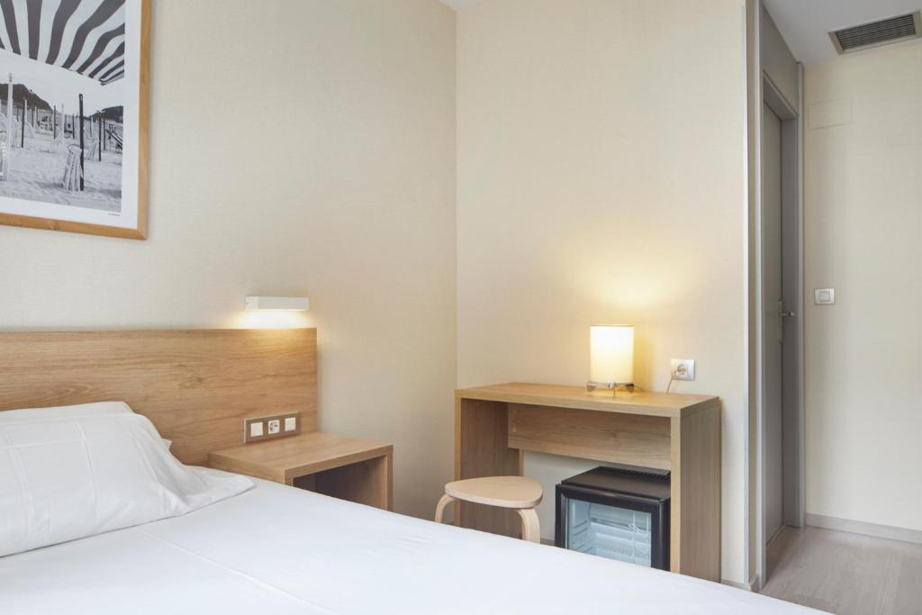 Postel nebo postele na pokoji v ubytování Welcome Gros Hotel