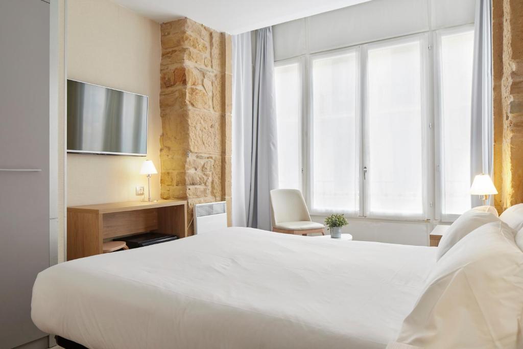 Postel nebo postele na pokoji v ubytování Welcome Gros Hotel