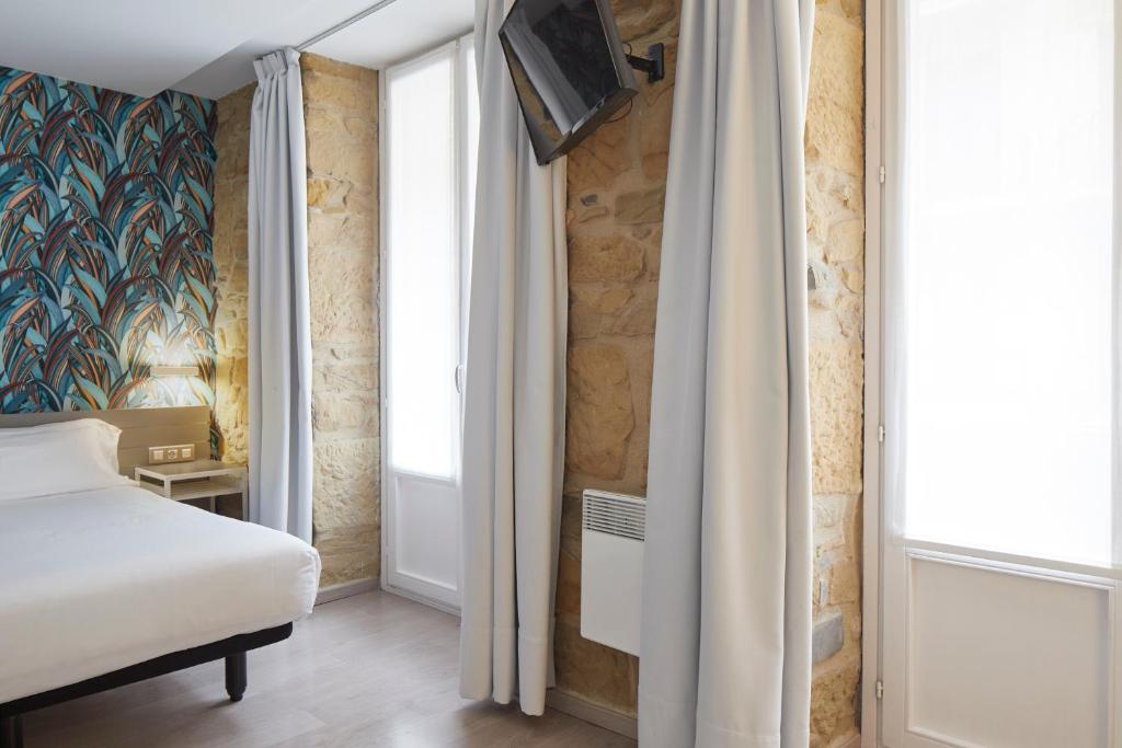 Postel nebo postele na pokoji v ubytování Welcome Gros Hotel