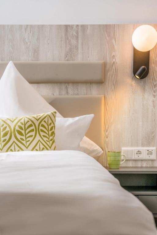 Postel nebo postele na pokoji v ubytování Parkhotel Wangerooge