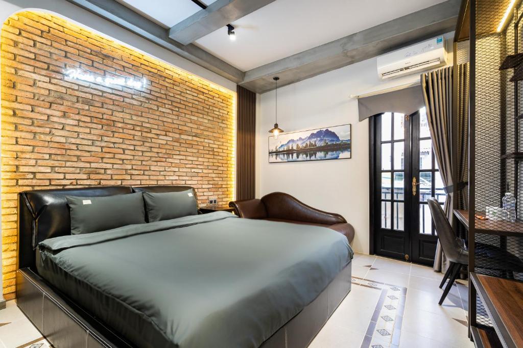 a bedroom with a bed and a brick wall at G9 Homestay - Đề Thám in Ho Chi Minh City