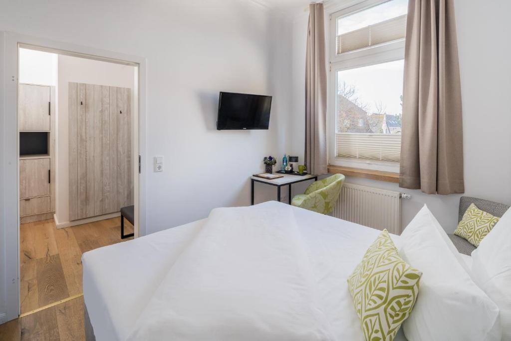 Postel nebo postele na pokoji v ubytování Parkhotel Wangerooge