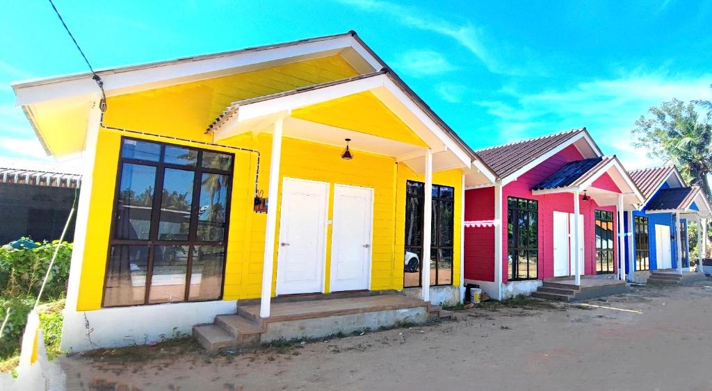 a row of colorful houses on a street at A’Casa Cottage in Kuala Terengganu
