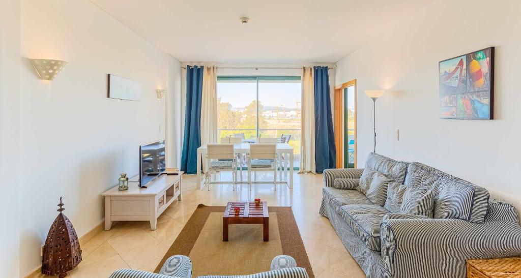 a living room with a couch and a table at Marina Vilamoura Aquamar 304 By Vilamoura Sun in Vilamoura