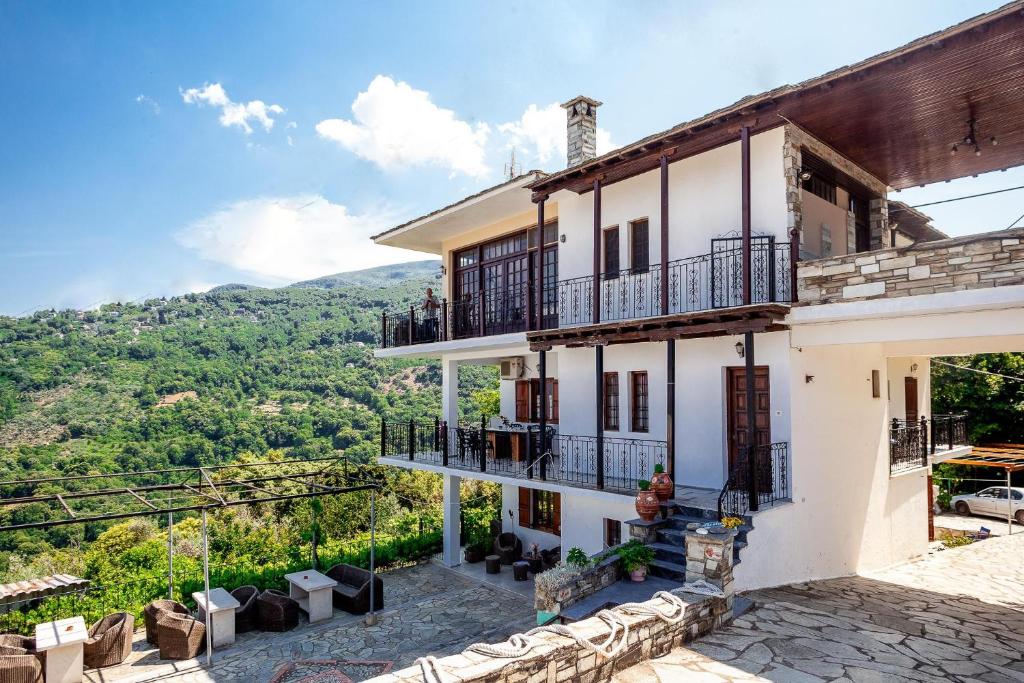 a house with a view of the mountains at Paradeisos Rooms Pelion in Agios Dimitrios
