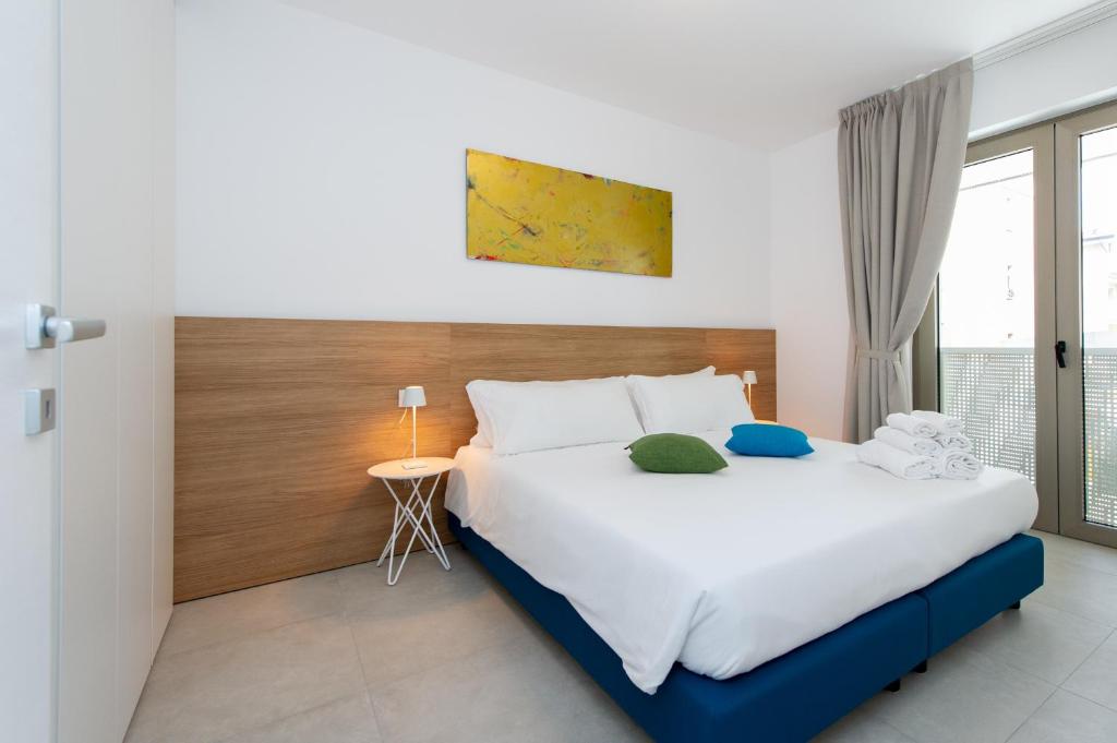 - une chambre avec un grand lit et une fenêtre dans l'établissement Ariston Teatro Luxury Aparthotel, à Grado