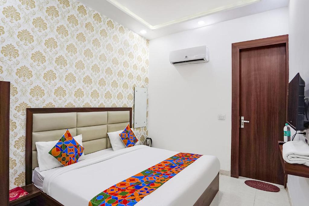 a bedroom with a bed in a room at FabHotel Swess in Agra