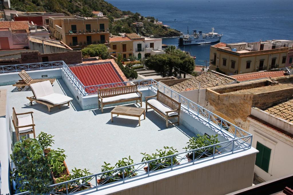 a balcony with chairs and a view of the ocean at Solares Case Vacanze in Ustica