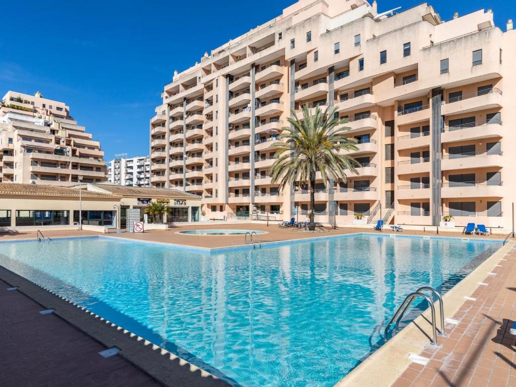 a large swimming pool in front of a large apartment building at Akisol Rocha Mar in Portimão