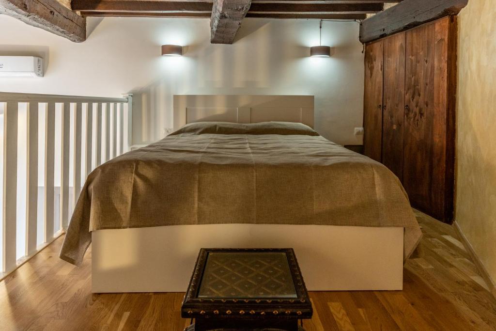 a bedroom with a large bed and a wooden floor at Solmi Home in Modena