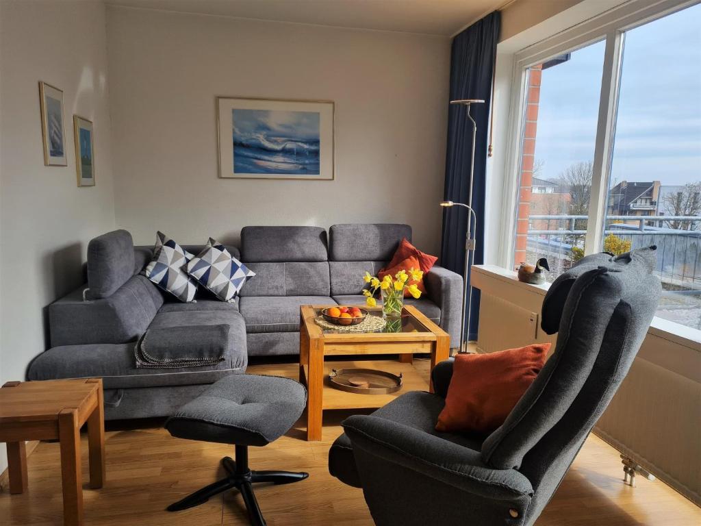 a living room with a couch and chairs and a table at "Appartement 6 - Feriennest" - ab sofort mit W-LAN in Grömitz
