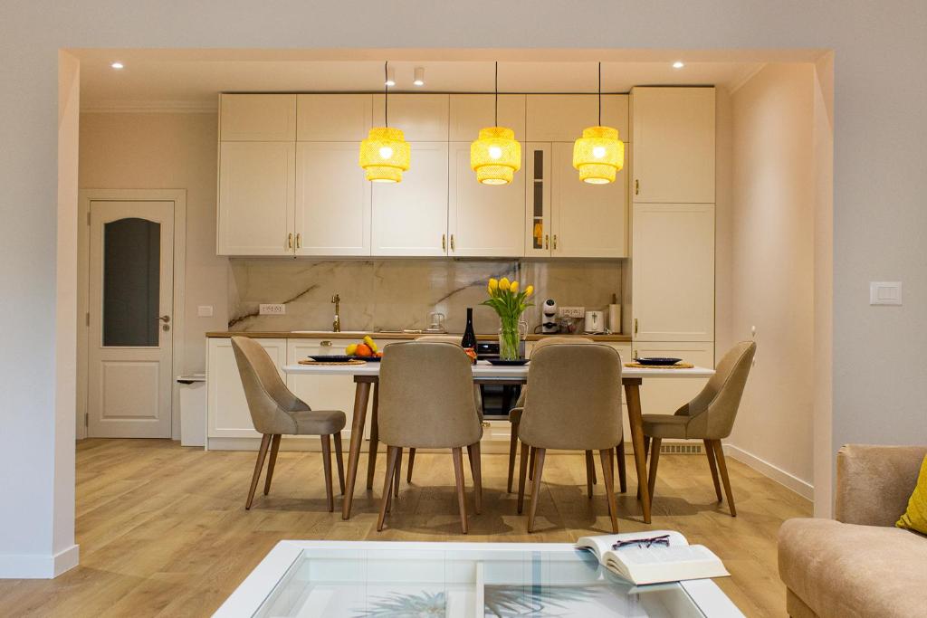a kitchen and dining room with a table and chairs at Grand Relax Cape Cod by RV Apartments in Varna City