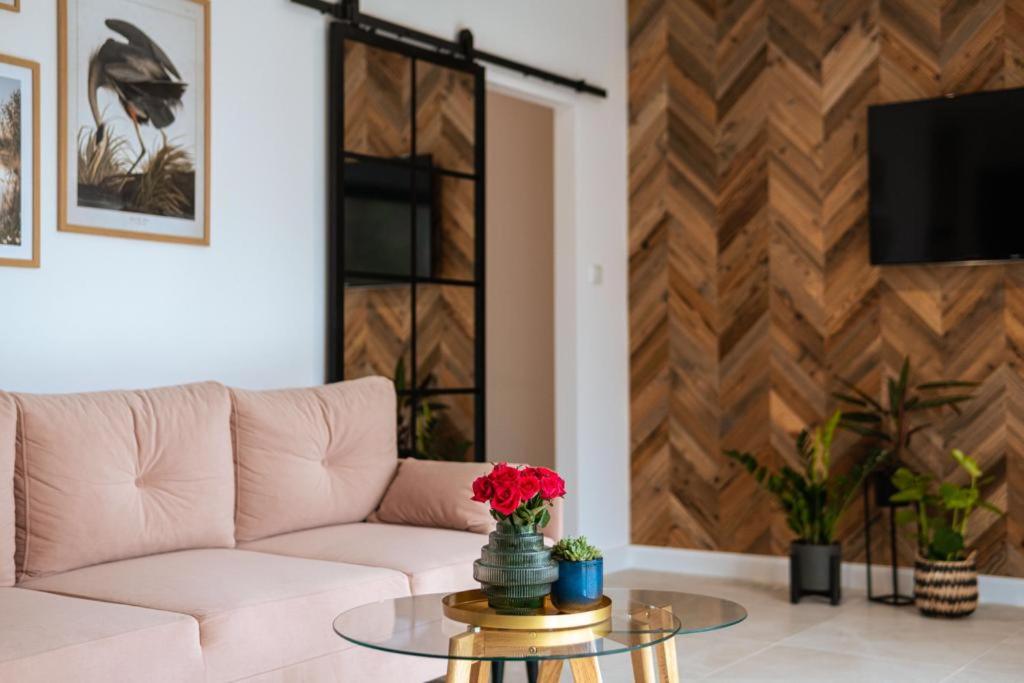 a living room with a couch and a table at Apartament J&T Mrągowo in Mrągowo