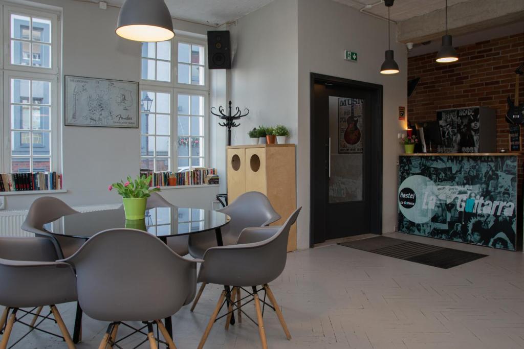 a dining room with a table and chairs at La Guitarra Hostel Gdańsk in Gdańsk