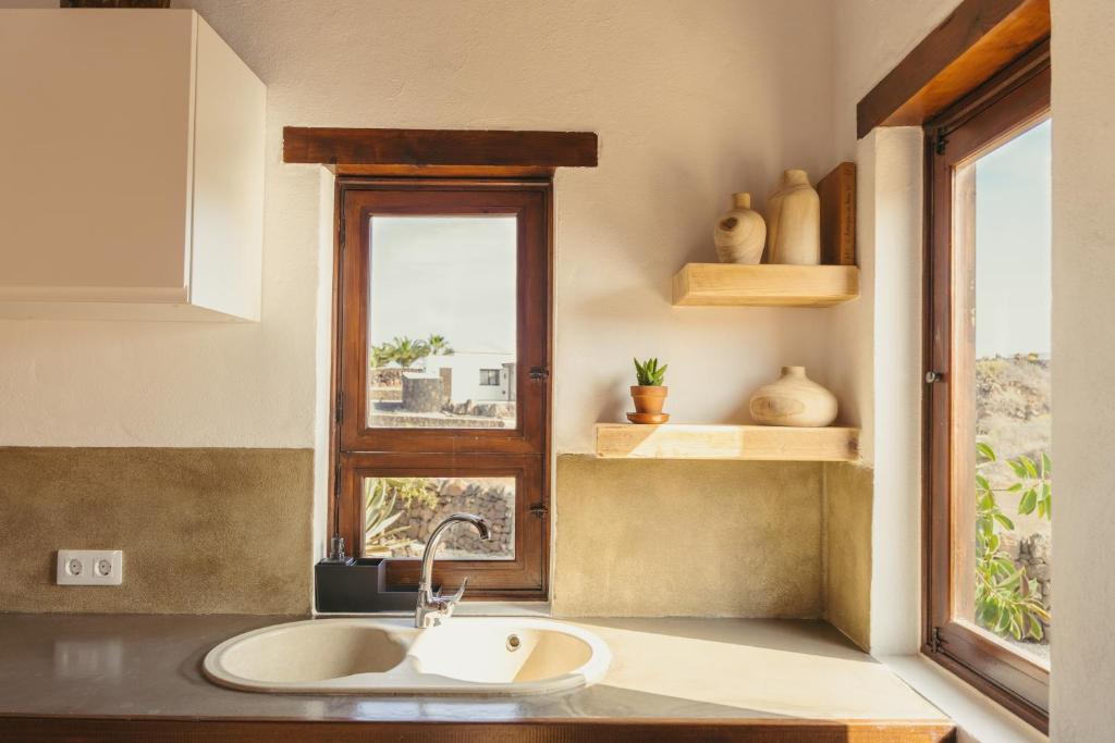 a kitchen with a sink and a window at Casa Maja in Lajares