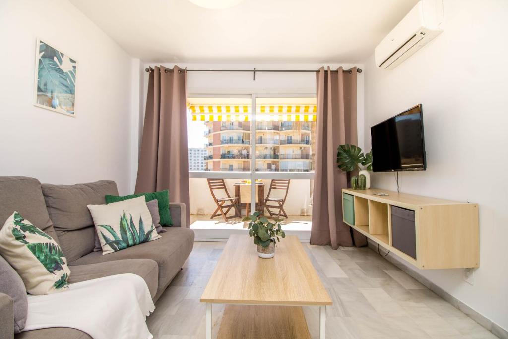 a living room with a couch and a tv at Erisa 55 by IVI Real Estate in Torremolinos