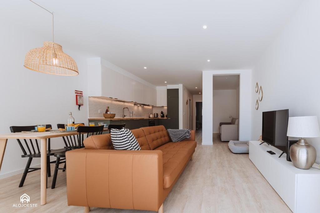 a living room with a brown couch and a table at The Terrace - Santa Cruz in Santa Cruz