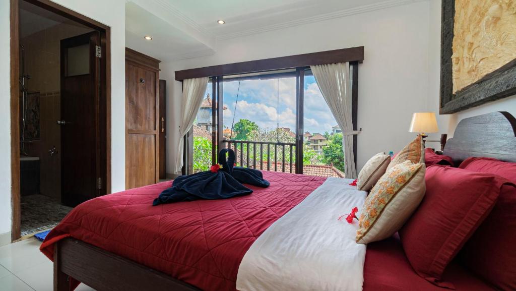 Postel nebo postele na pokoji v ubytování Kun - Kun Guest House Ubud