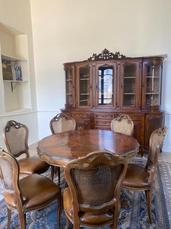 a dining room with a wooden table and chairs at Central house with beautiful garden in Amman