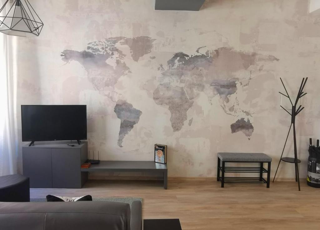 a living room with a world map on the wall at RivApartmentsDowntowN Travel in Riva del Garda