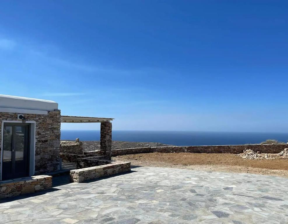 a building with a view of the ocean at Rustic Stone House in the Heart of Folegandros in Áno Meriá
