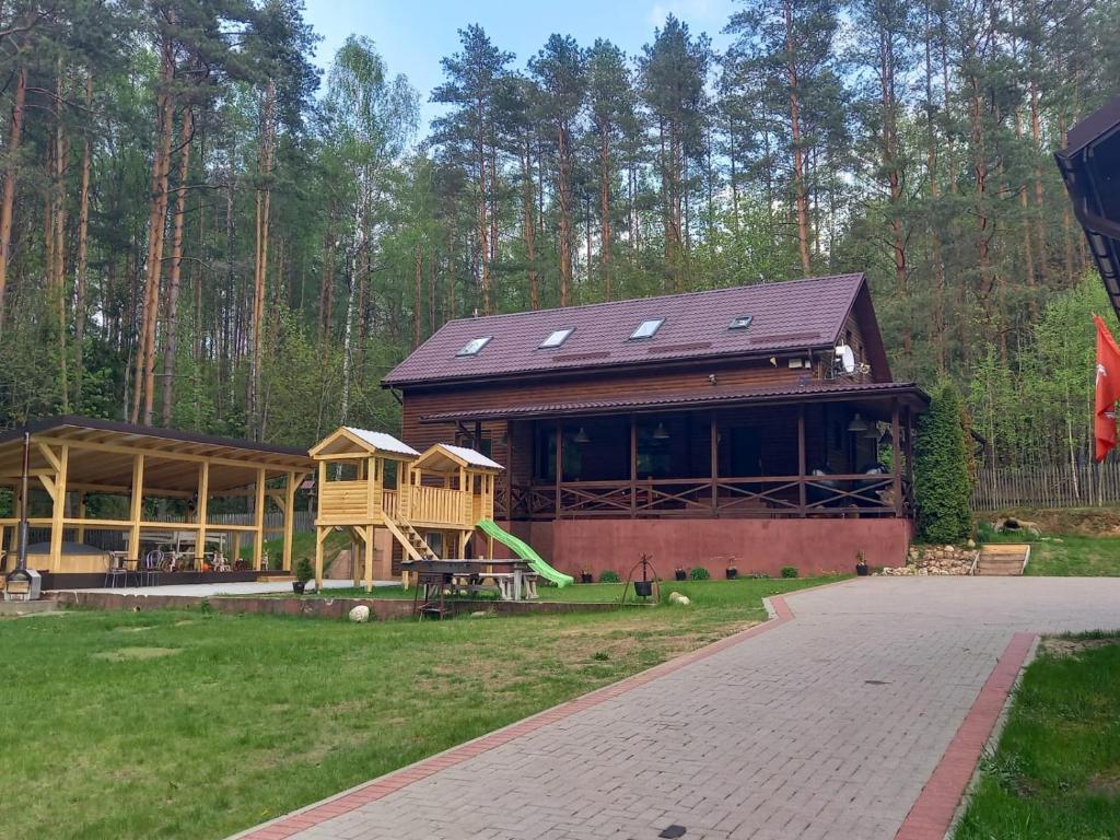 a large house with a playground in the yard at Lesnoj holiday in Vilnius