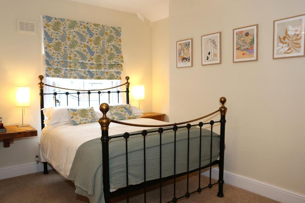 a bedroom with a large bed with a canopy at The Waves in Scarborough