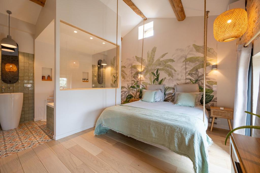 a bedroom with a bed and a large mirror at Songes de vigne in Bagnols