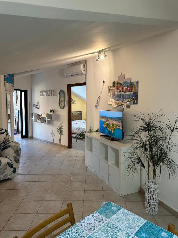 a living room with a tv on a wall at Il Bacio del Mare in Agropoli
