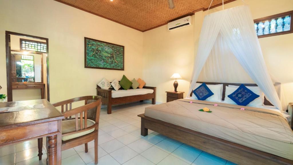 Postel nebo postele na pokoji v ubytování Cafe Wayan Cottages Senggigi