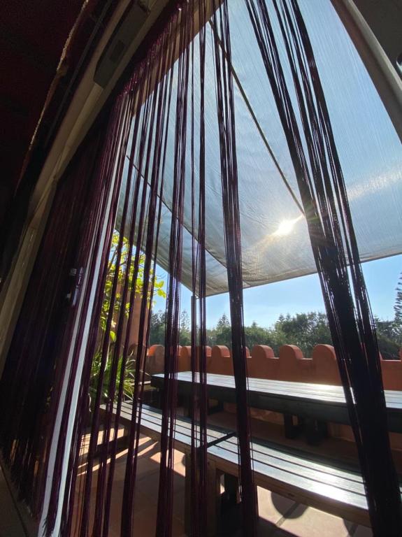 a window with a view of a couch through it at Raid Garden Boutique Hotel in Magong