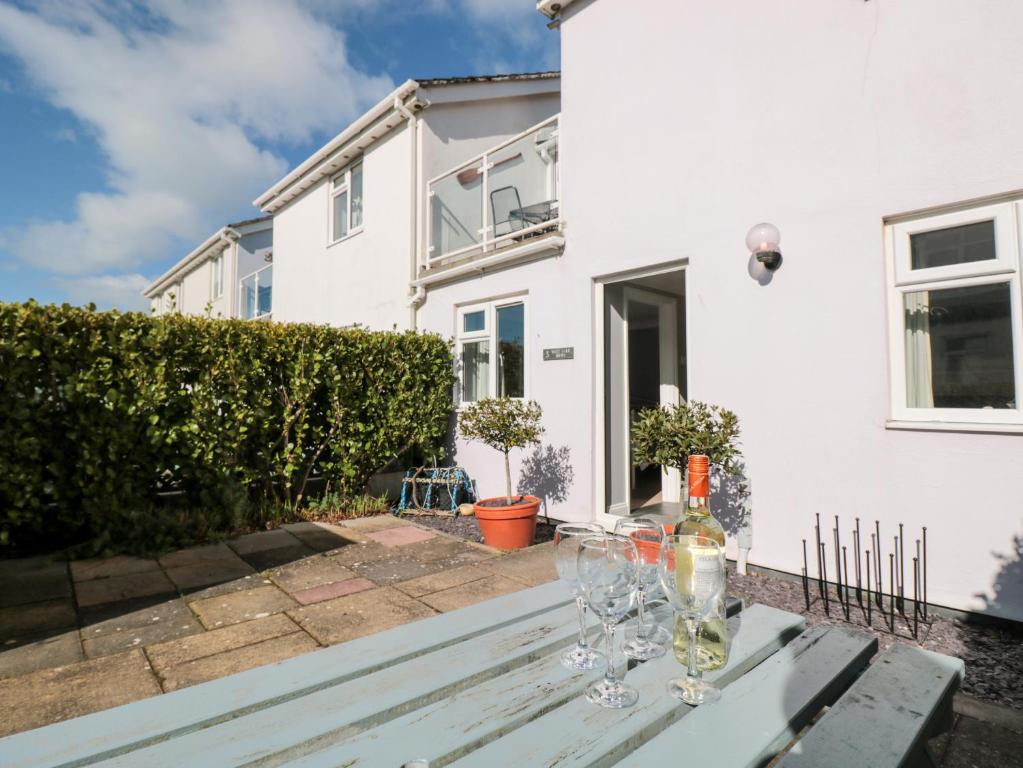 a table with wine glasses on it in front of a house at 3 West Park Mews in Kingsbridge
