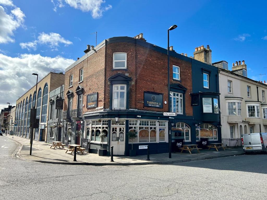 a brick building on the corner of a street at Starboard Stays in Southampton