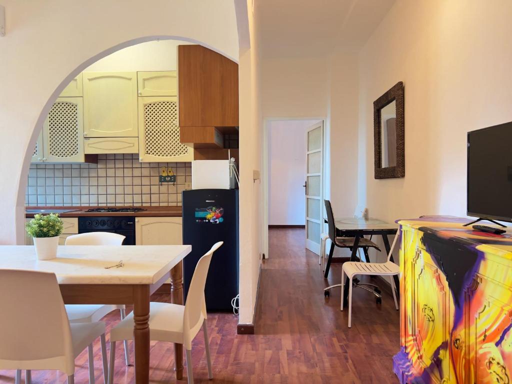 a kitchen and dining room with a table and a refrigerator at Appartme Morazzone 7 in Milan