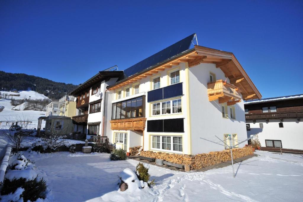 a large building with snow on the ground at Appartement Erika in Hopfgarten im Brixental