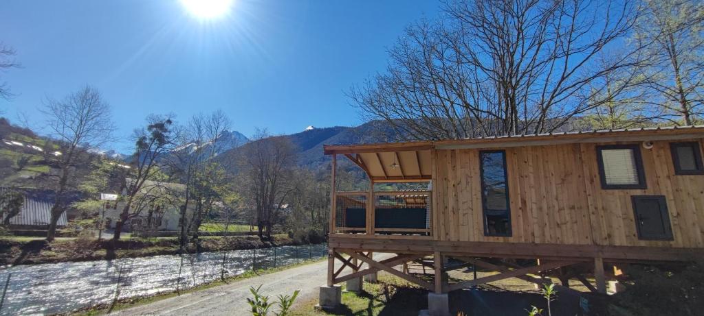 a log cabin with a view of a mountain at Camping des Gaves in Laruns