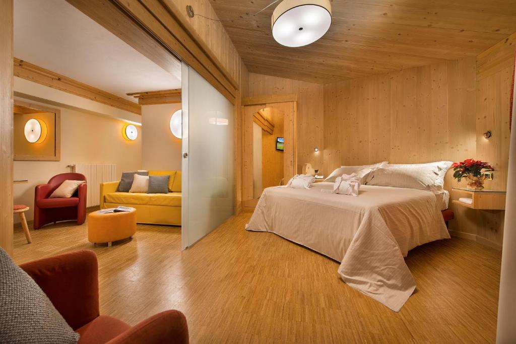 Postel nebo postele na pokoji v ubytování Hotel Baita Montana