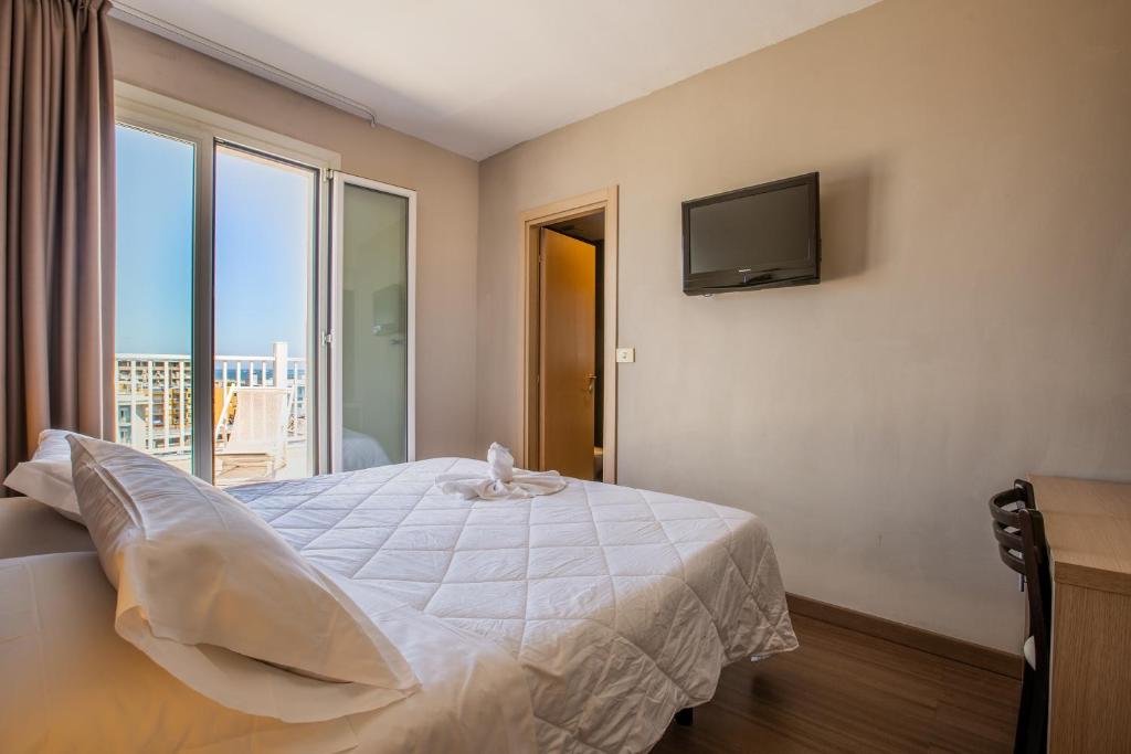 Postel nebo postele na pokoji v ubytování Hotel Aiglon
