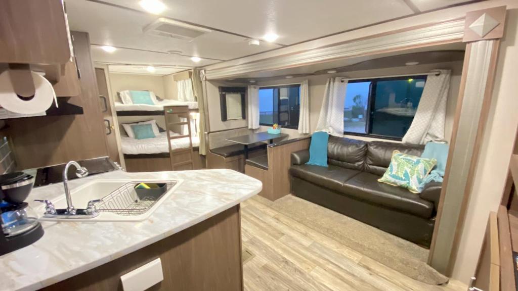 a kitchen and living room in a recreational vehicle at Glamping on the Bay with fishing dock in Bolivar Peninsula
