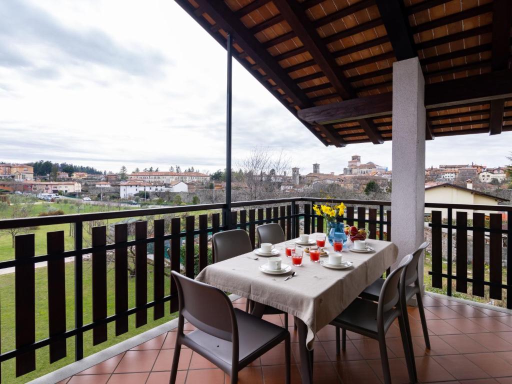 a table on the balcony with a view of the city at Apartment Casa Monte Nero by Interhome in Cividale del Friuli