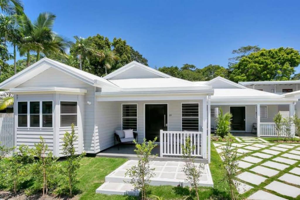 a white house with a porch at Coastal Villa in Edge Hill