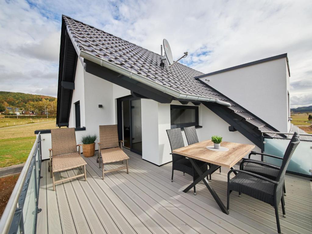 a wooden deck with a table and chairs on it at Apartment Landliebe by Interhome 