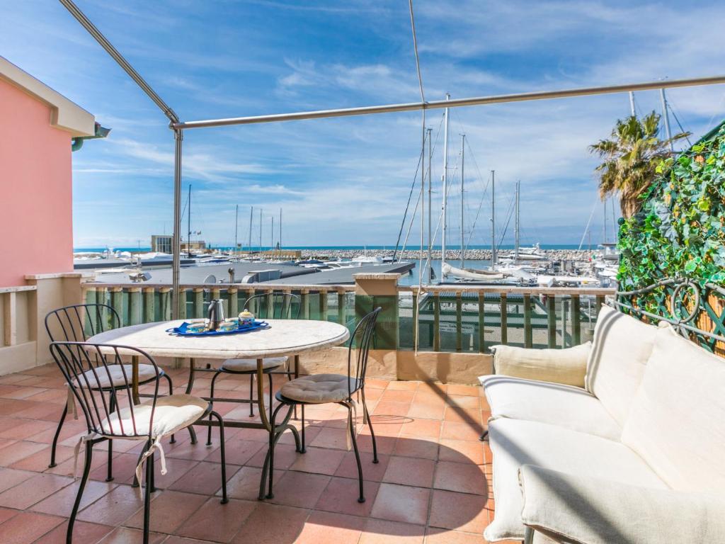 a balcony with a table and chairs and a view of a harbor at Apartment Ponente N-2 by Interhome in San Vincenzo