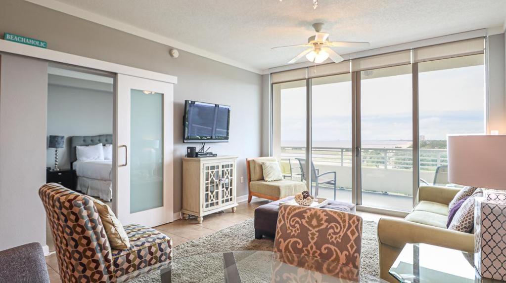 a living room with a couch and a tv at Ocean Club 502 in Biloxi