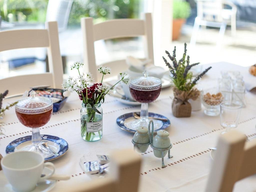 a table with two wine glasses on top of it at Birch House Bed & Breakfast in Weymouth