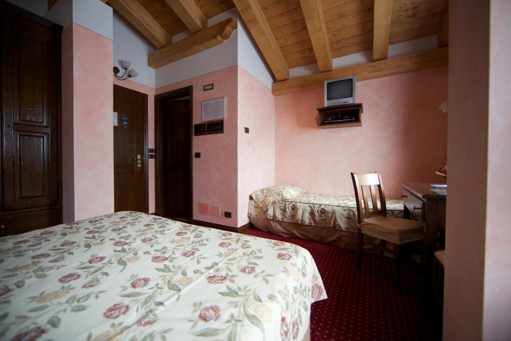Postel nebo postele na pokoji v ubytování Hotel L' Aiglon