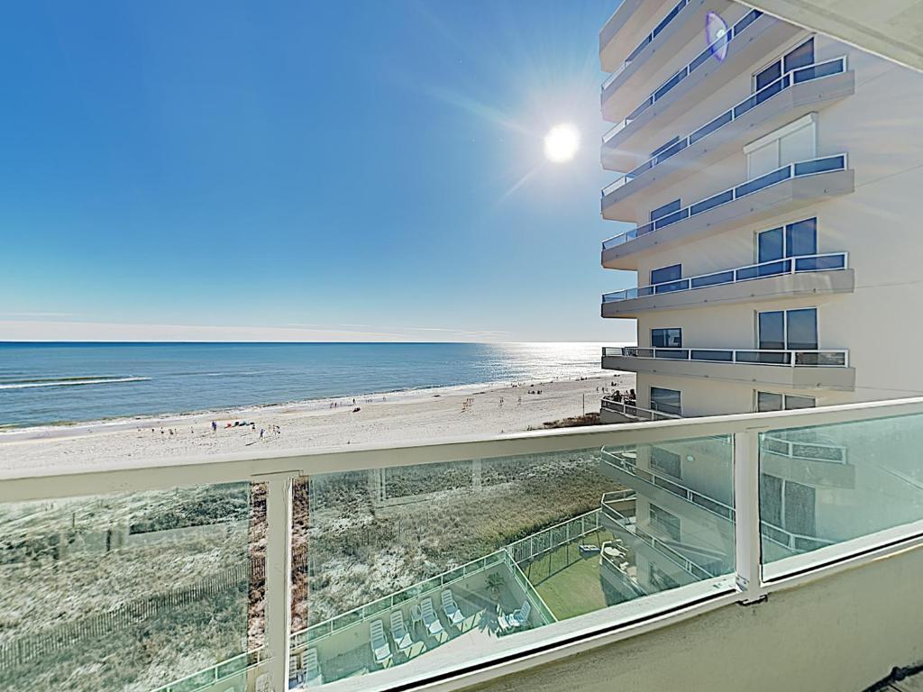 a balcony with a view of the beach and a building at Silver Beach 506 orange Beach in Orange Beach