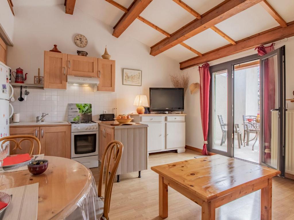 a kitchen with a table and a dining room at Apartment L'Aquillon by Interhome in Noves