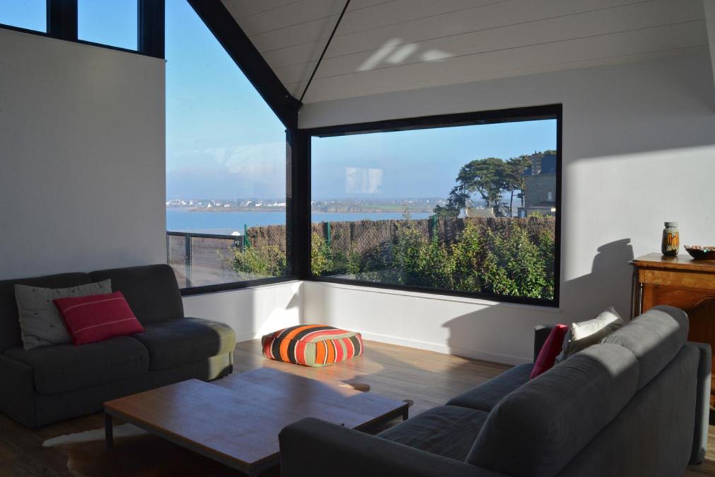 a living room with a view of the ocean at Villa 1 in Saint-Jacut-de-la-Mer